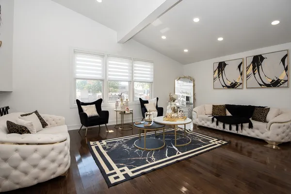 a living room with furniture gym equipment and wooden floor