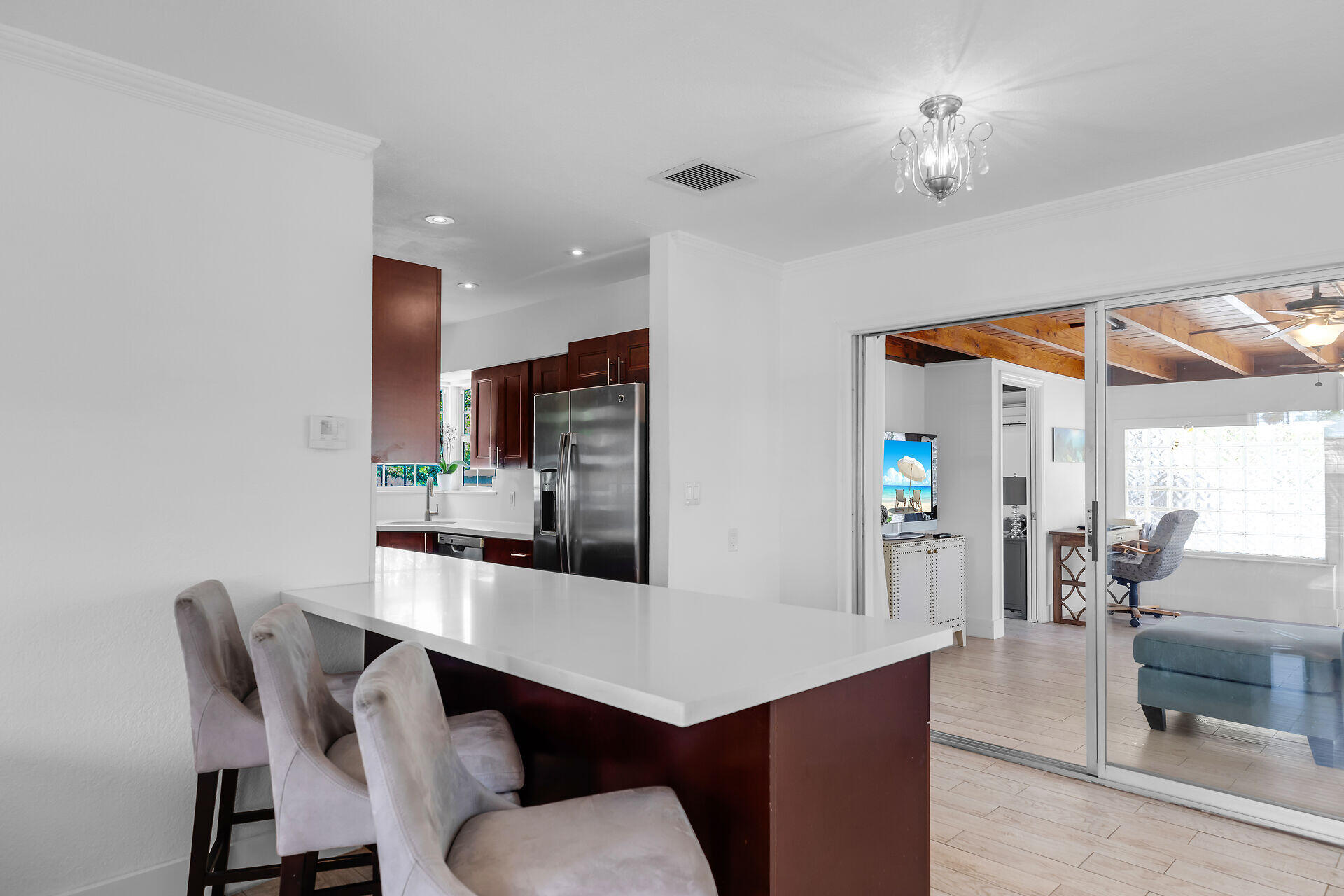 690 79th Street Marathon, FL 33050 - Photo 13 of 45 a kitchen with stainless steel appliances kitchen island granite countertop a dining table chairs and a refrigerator