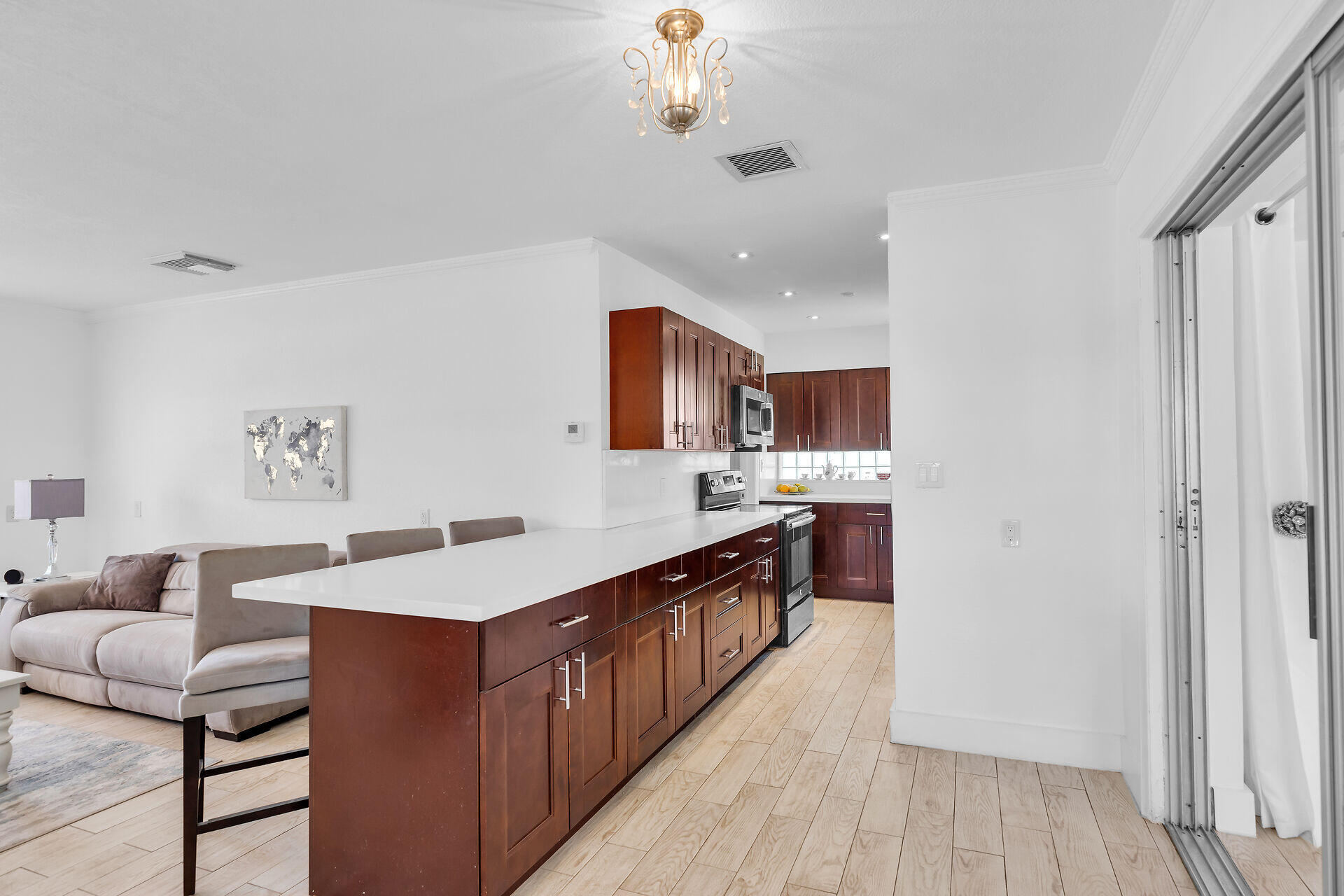 690 79th Street Marathon, FL 33050 - Photo 14 of 45 a kitchen with stainless steel appliances granite countertop a refrigerator a sink dishwasher a stove and a dining table with wooden floor