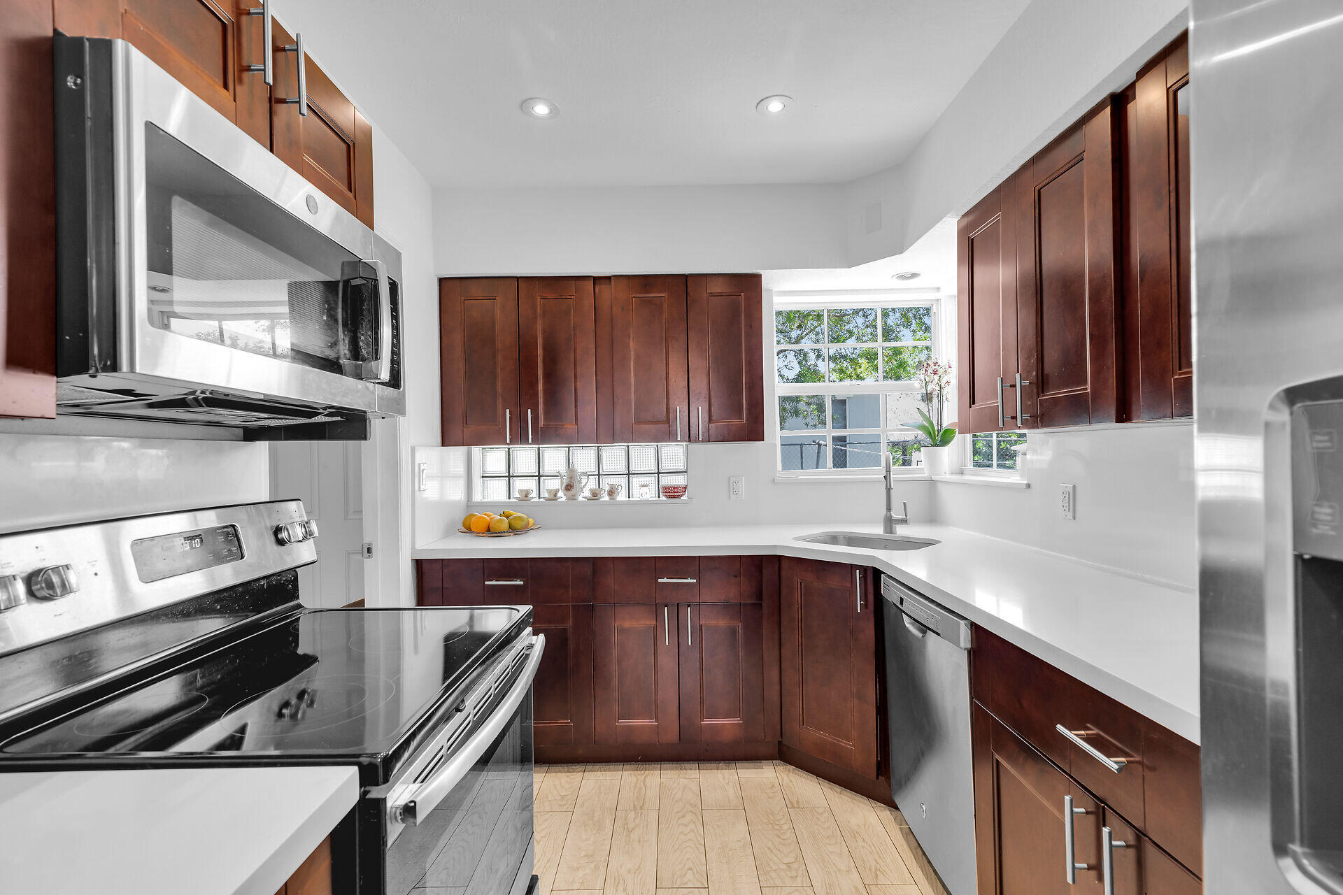690 79th Street Marathon, FL 33050 - Photo 17 of 45 a kitchen with wooden cabinets stove top oven and sink