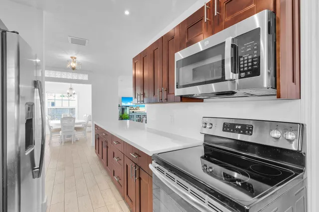 a kitchen with wooden cabinets and a stove top oven