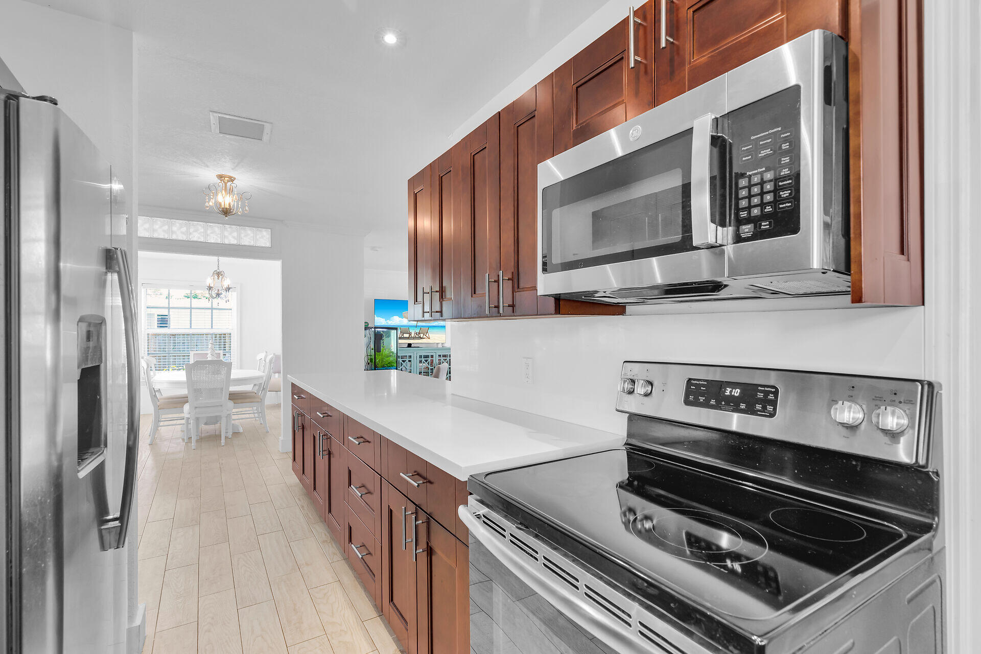 690 79th Street Marathon, FL 33050 - Photo 18 of 45 a kitchen with wooden cabinets and a stove top oven