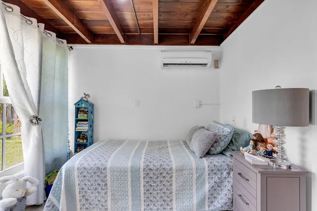 a bedroom with a bed a couch and a window