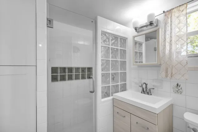 a bathroom with a sink toilet and shower