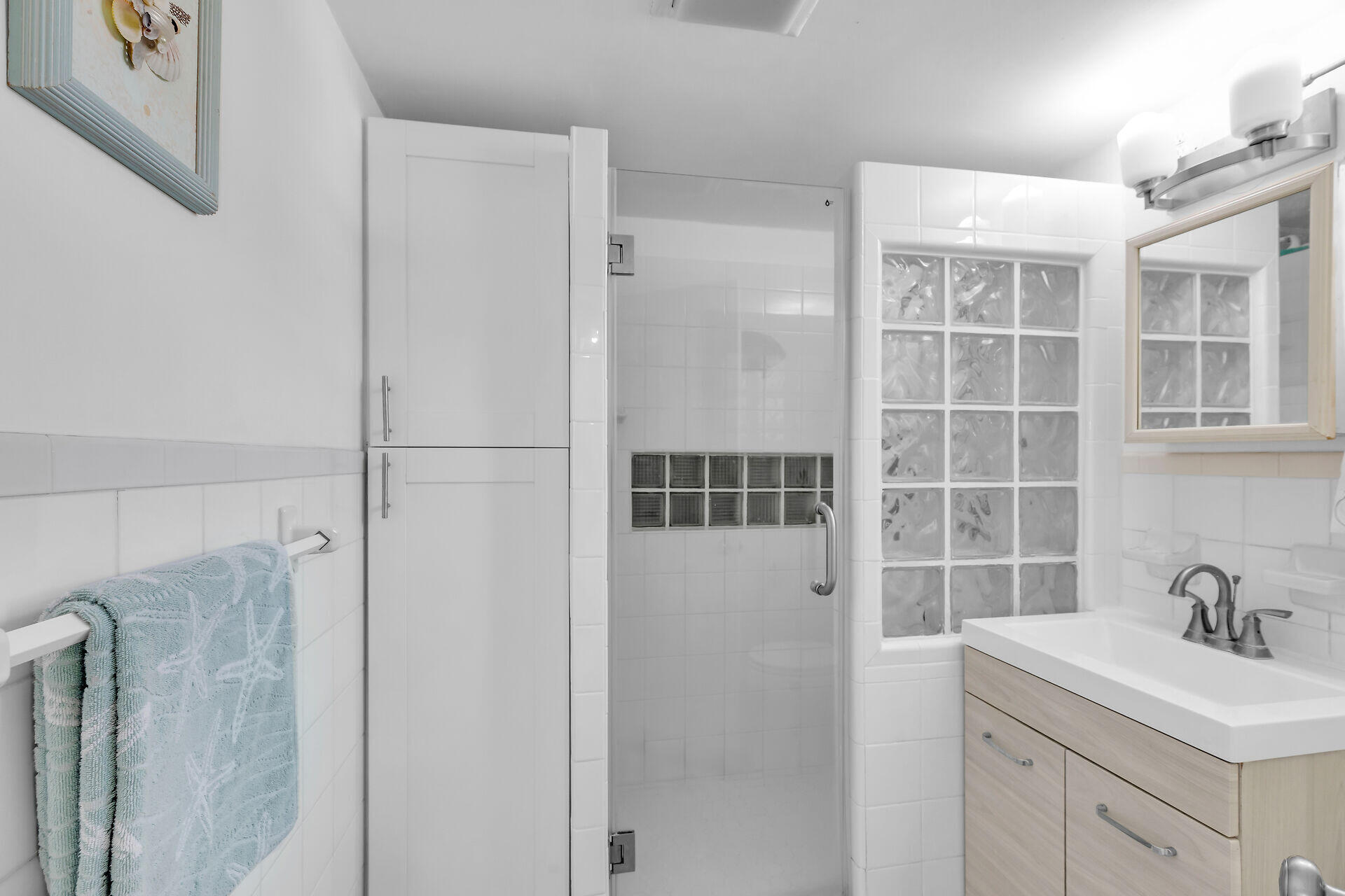 690 79th Street Marathon, FL 33050 - Photo 25 of 45 a bathroom with a sink and mirror with shower