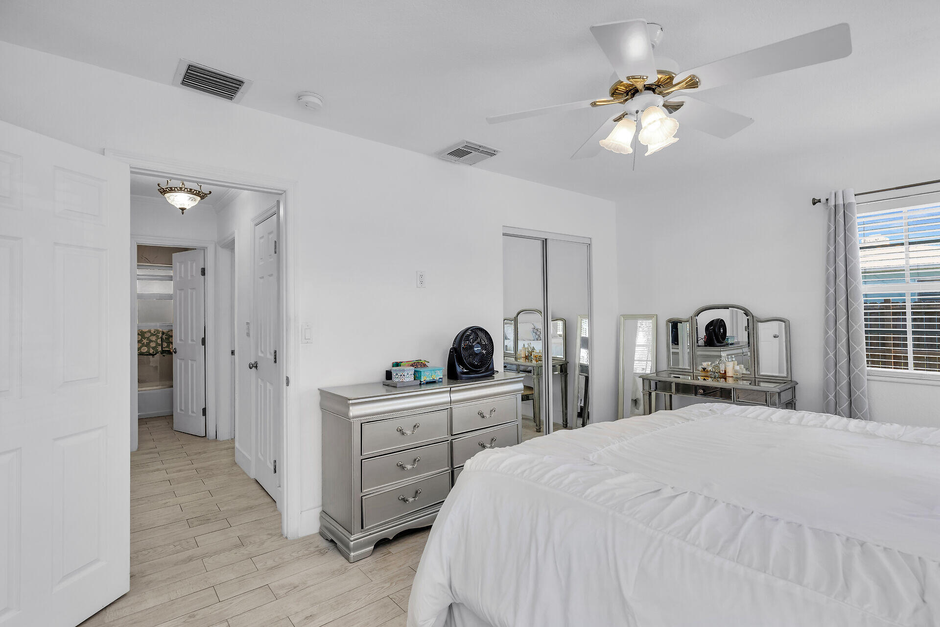 690 79th Street Marathon, FL 33050 - Photo 27 of 45 a bedroom with a bed and a chandelier