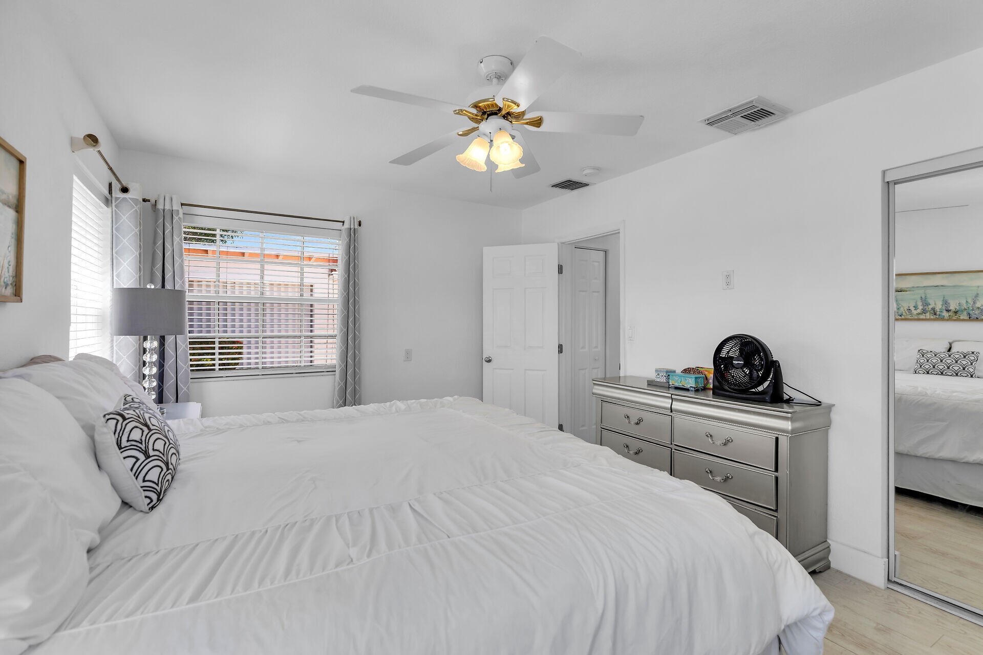 690 79th Street Marathon, FL 33050 - Photo 28 of 45 a bedroom with a bed and a chandelier