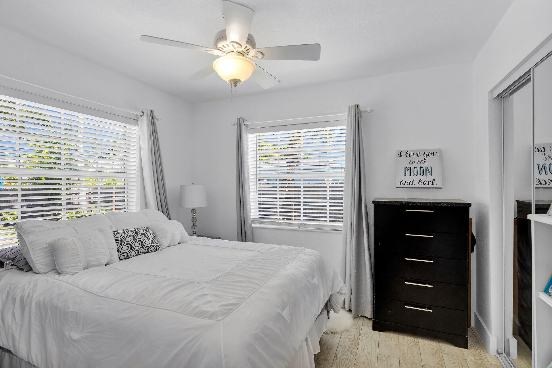 690 79th Street Marathon, FL 33050 - Photo 32 of 45 a bedroom with a bed and a chandelier