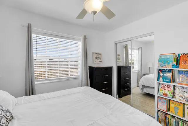 a bedroom with a bed and a book shelf