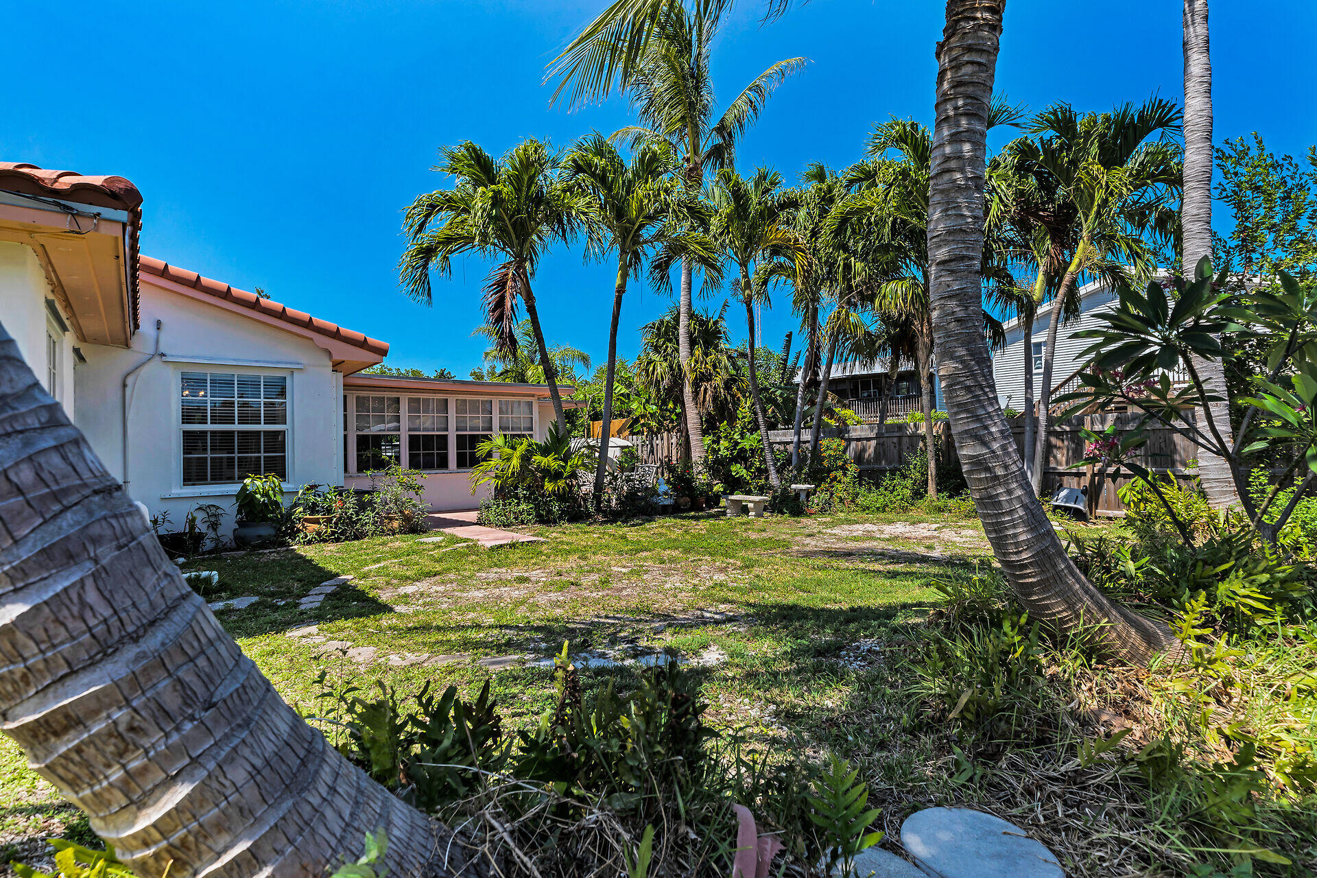 690 79th Street Marathon, FL 33050 - Photo 39 of 45 front view of a house with a yard and potted plants
