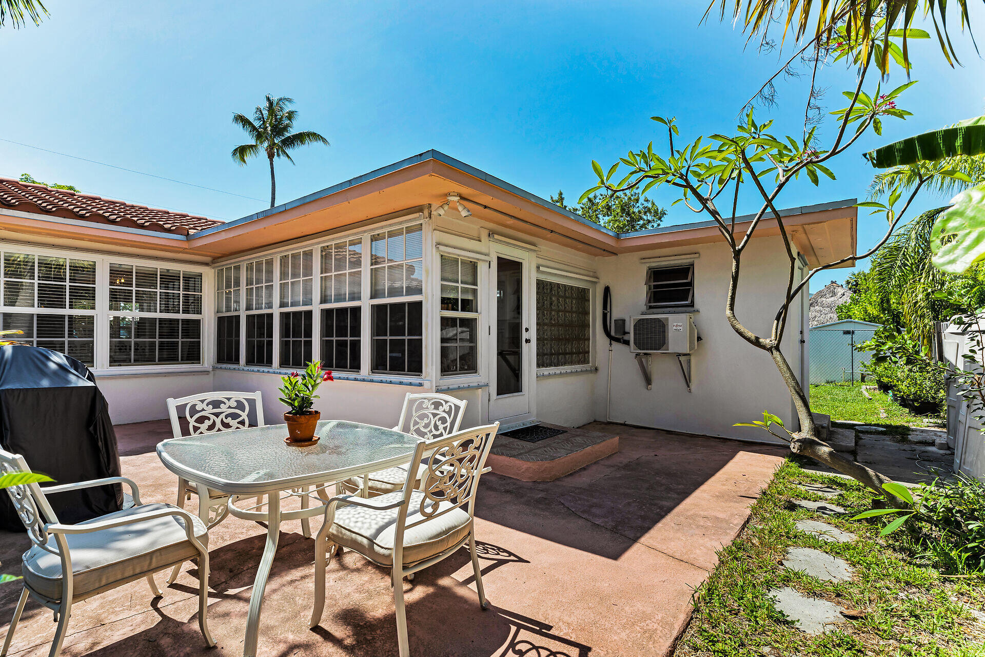 690 79th Street Marathon, FL 33050 - Photo 41 of 45 a front view of a house with a yard glass table and chairs