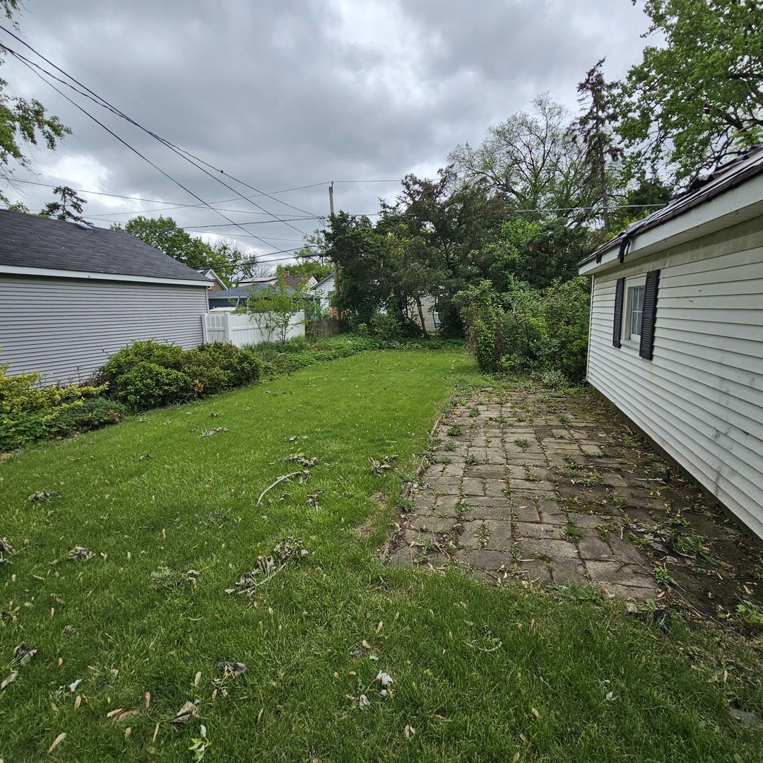 237 Pine Street Villa Park, IL 60181 - Photo 4 of 13 a backyard of a house with plants and large trees