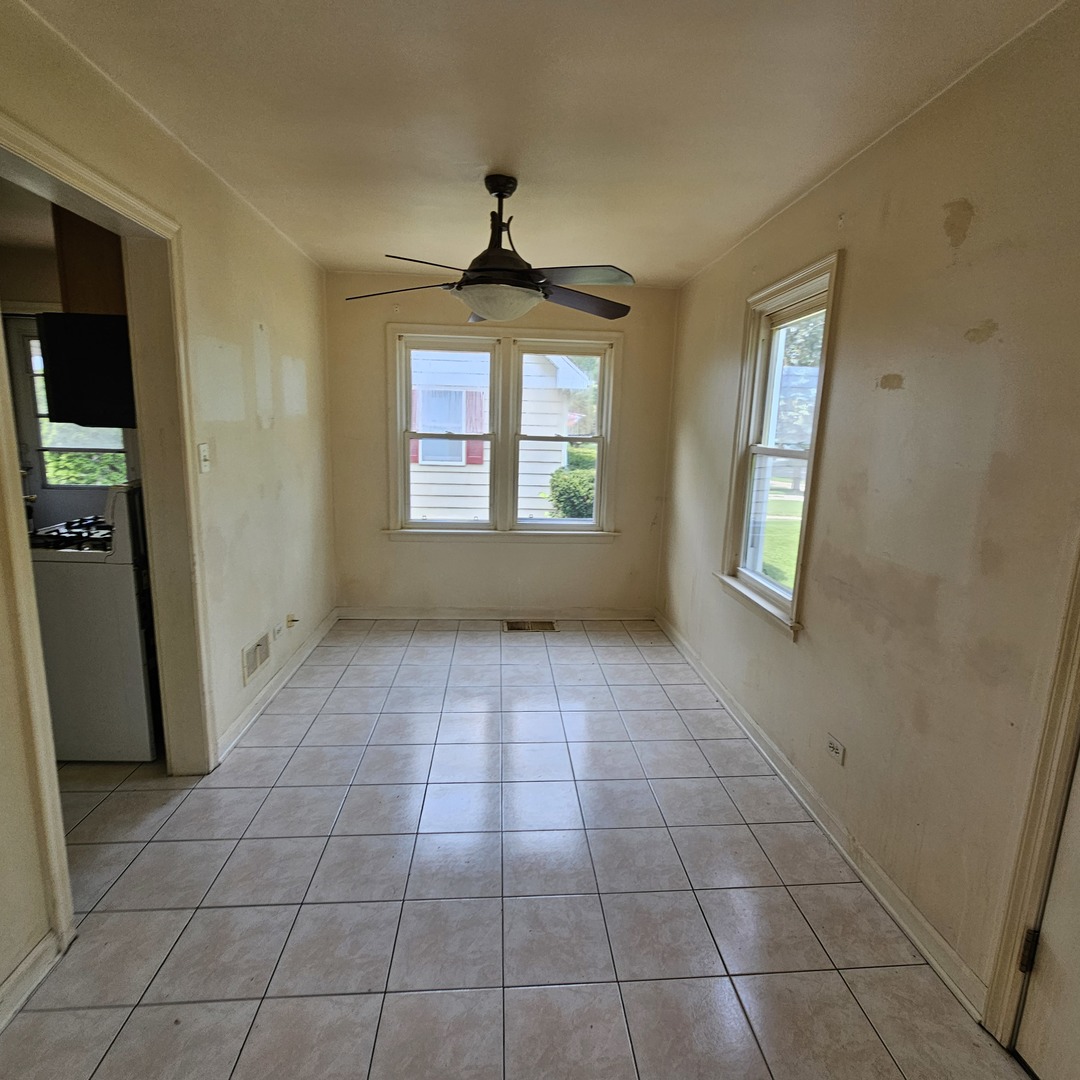 237 Pine Street Villa Park, IL 60181 - Photo 8 of 13 a view of an empty room with window and chandelier fan