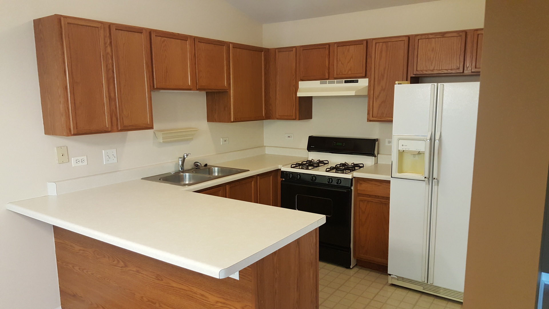 1197 North Red Oak Circle, Unit 3 Round Lake Beach, IL 60073 - Photo 12 of 16 a kitchen with a sink a stove and a refrigerator