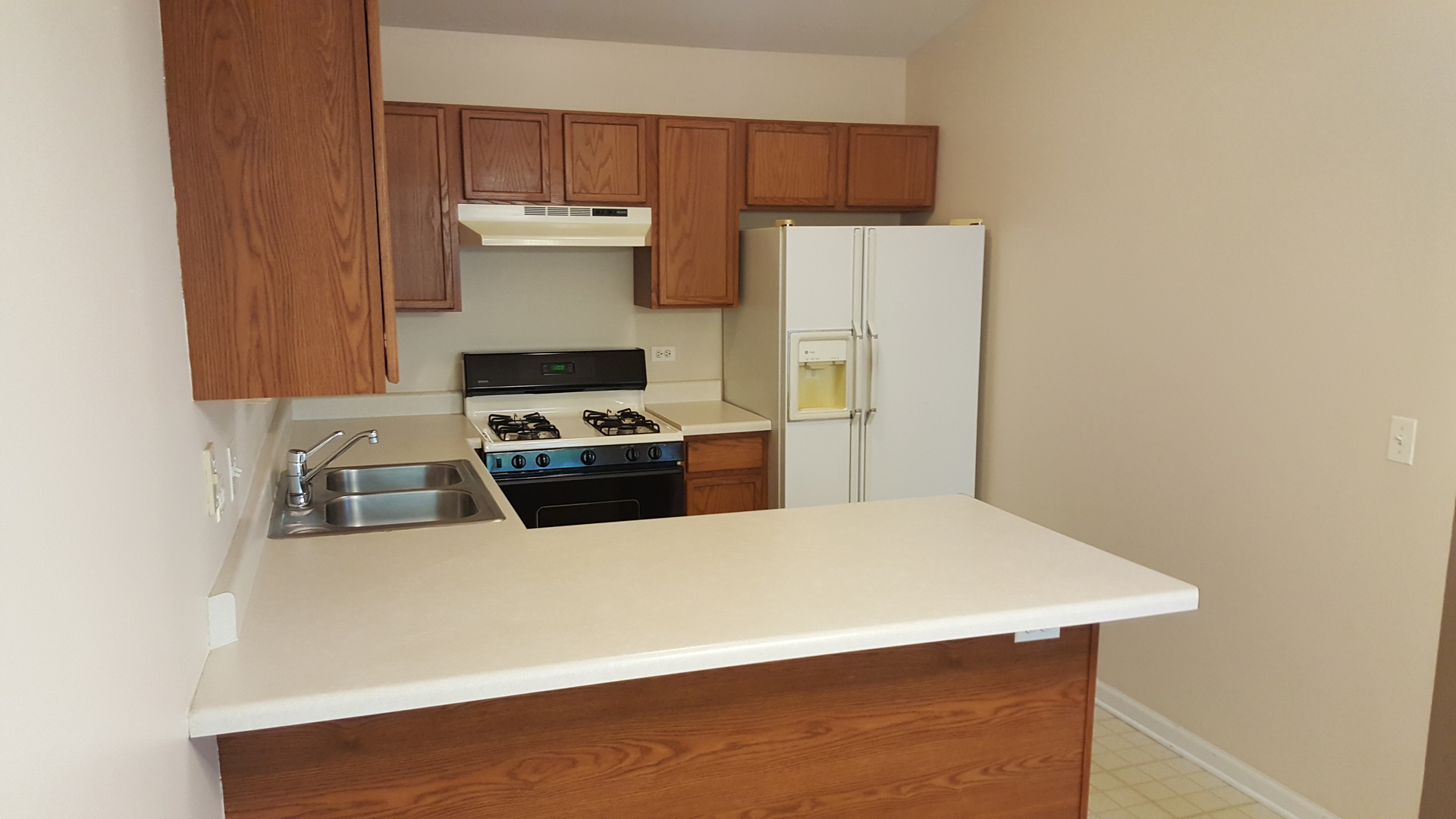 1197 North Red Oak Circle, Unit 3 Round Lake Beach, IL 60073 - Photo 13 of 16 a kitchen with a refrigerator and a stove