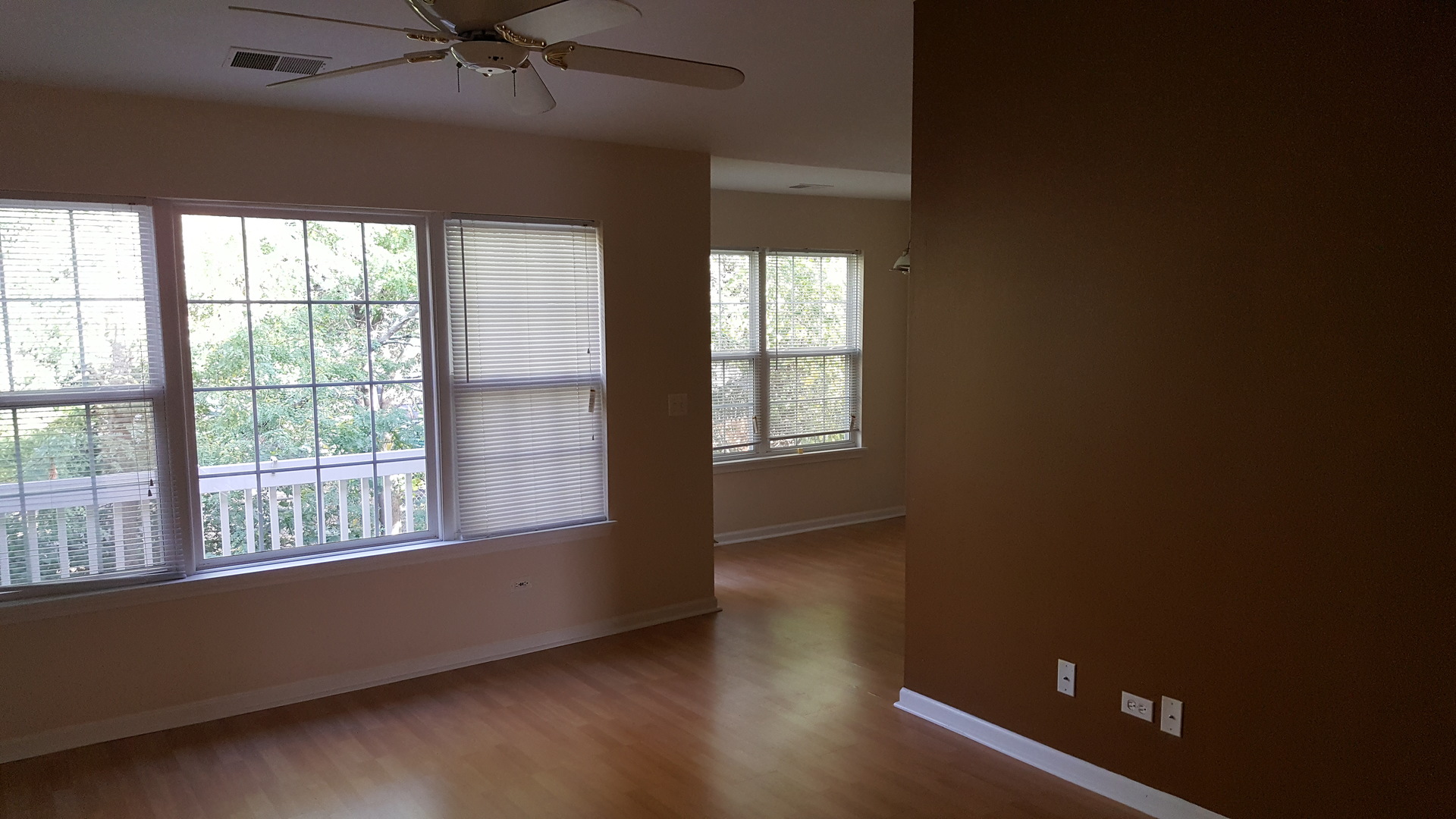 1197 North Red Oak Circle, Unit 3 Round Lake Beach, IL 60073 - Photo 10 of 16 an empty room with wooden floor fan and windows