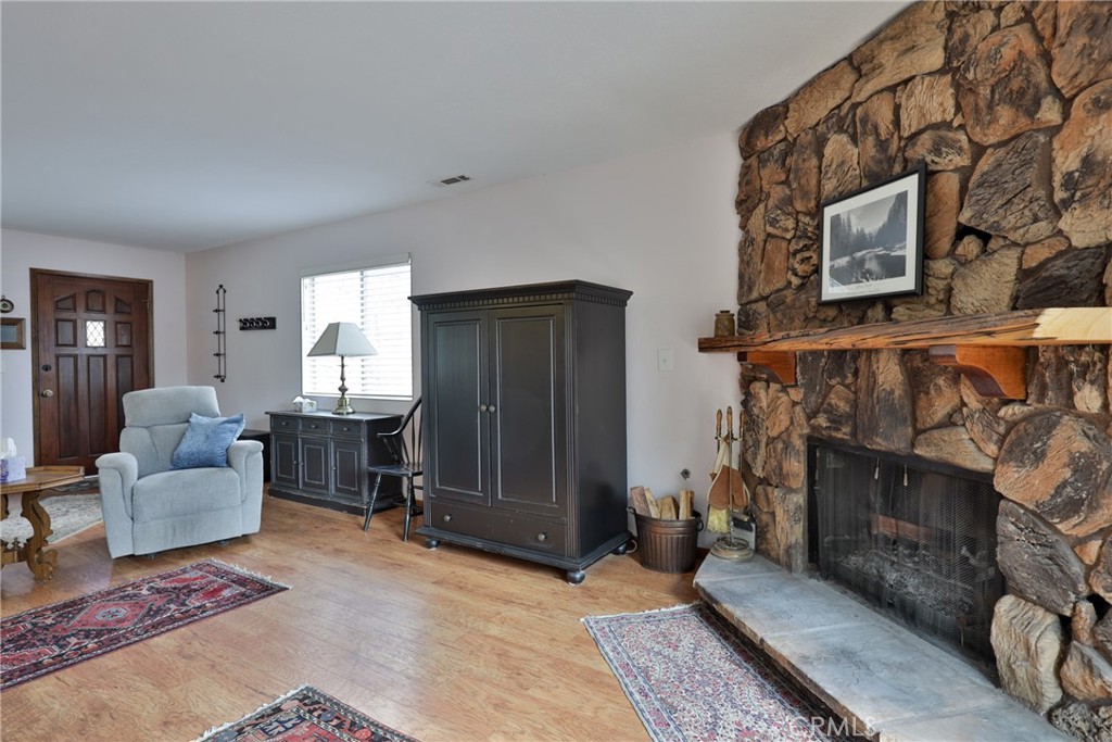 39177 Arapahoe Road Fawnskin, CA 92333 - Photo 13 of 39 a living room with furniture a window and a fireplace