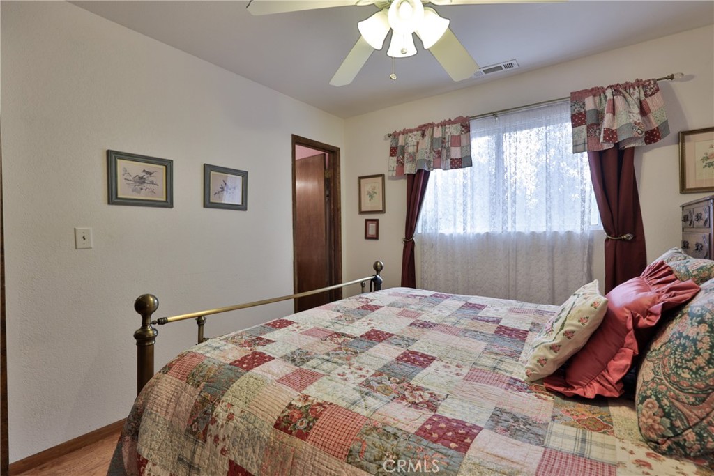 39177 Arapahoe Road Fawnskin, CA 92333 - Photo 18 of 39 a bedroom with a bed and a chandelier