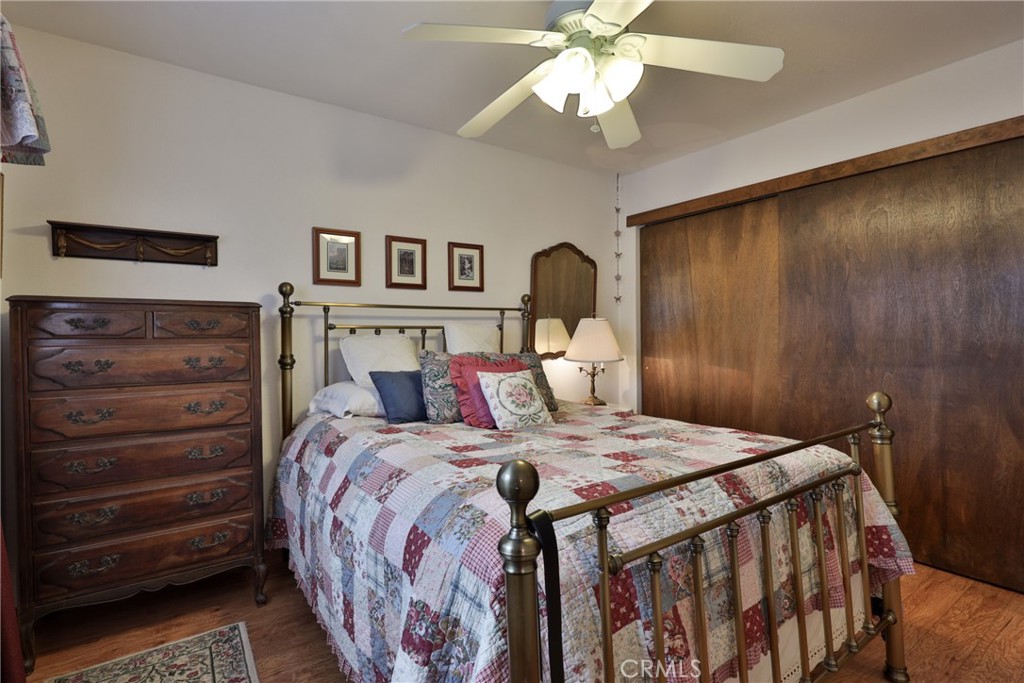 39177 Arapahoe Road Fawnskin, CA 92333 - Photo 19 of 39 a bedroom with a bed and a chandelier