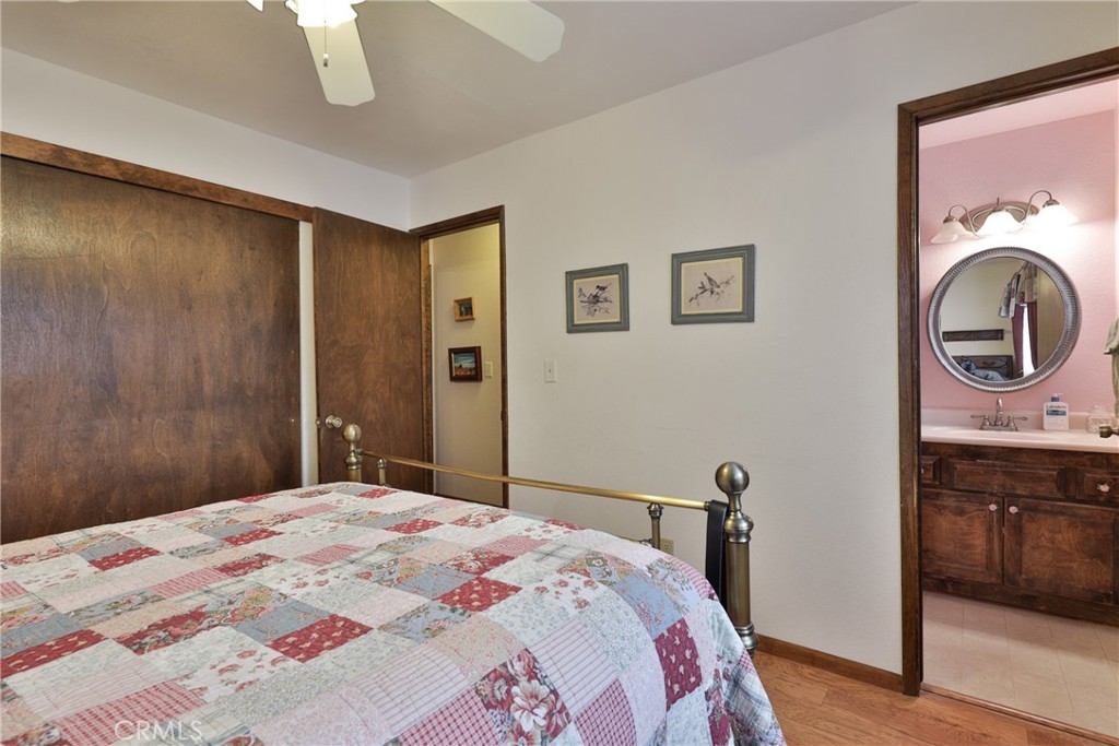 39177 Arapahoe Road Fawnskin, CA 92333 - Photo 20 of 39 a bedroom with a bed and a mirror