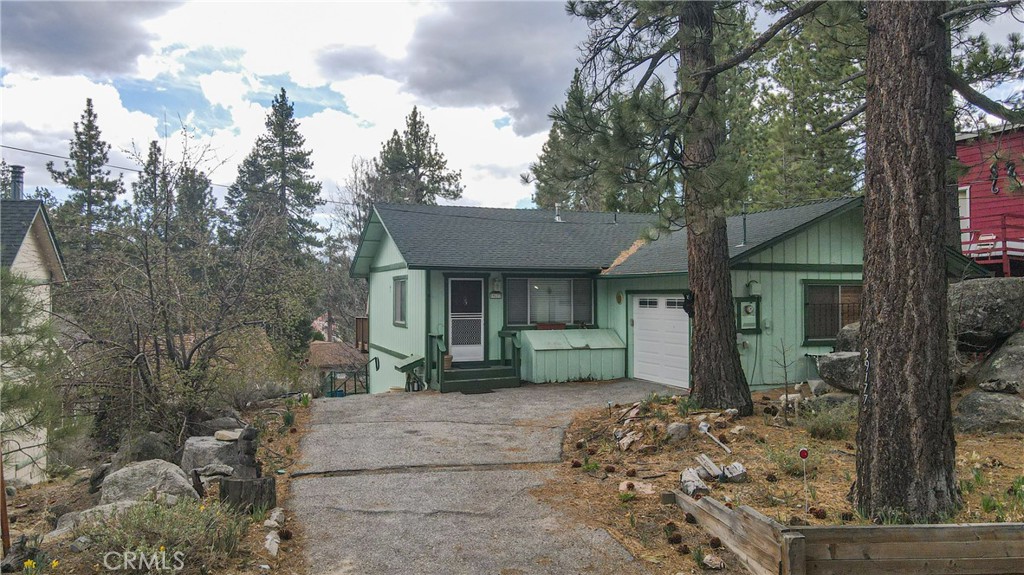 39177 Arapahoe Road Fawnskin, CA 92333 - Photo 3 of 39 a front view of a house with a yard and garage