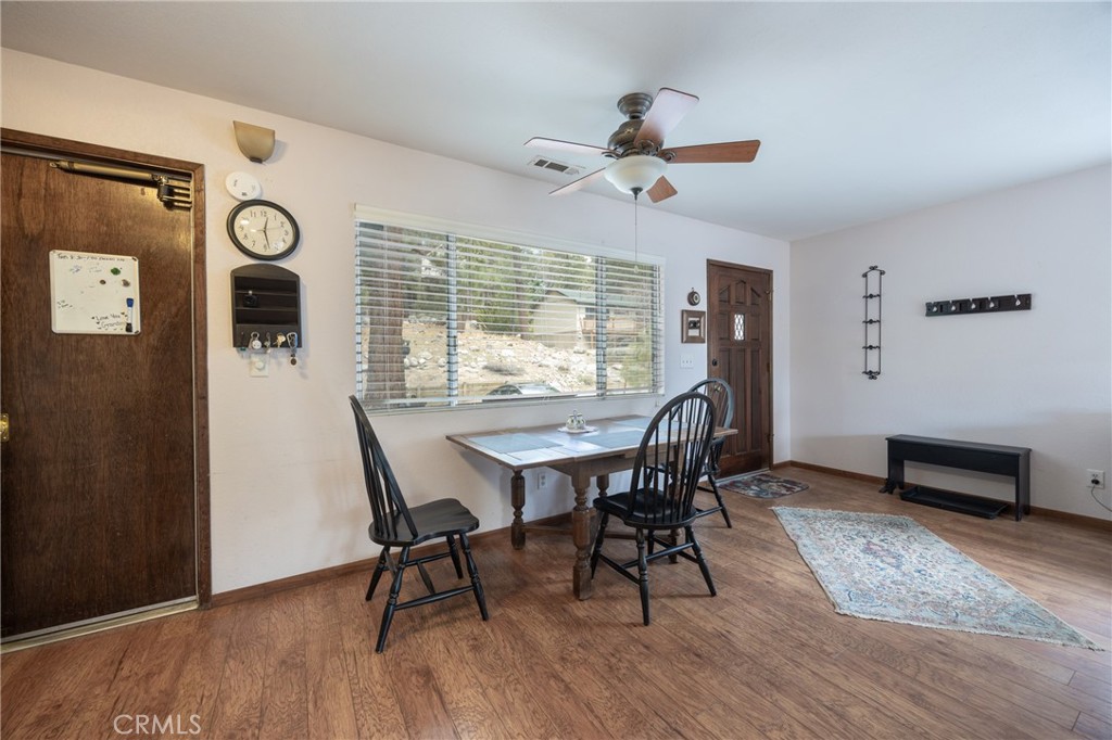 39177 Arapahoe Road Fawnskin, CA 92333 - Photo 9 of 39 a view of a dining room with furniture window and wooden floor