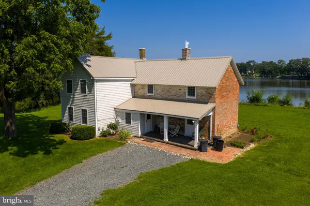 a view of a house with a yard and sitting area
