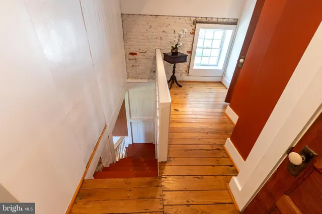 a bedroom with furniture and a wooden floor
