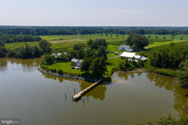 an aerial view of a house with a lake view