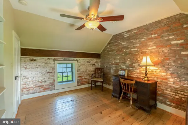 a workspace room with furniture and wooden floor