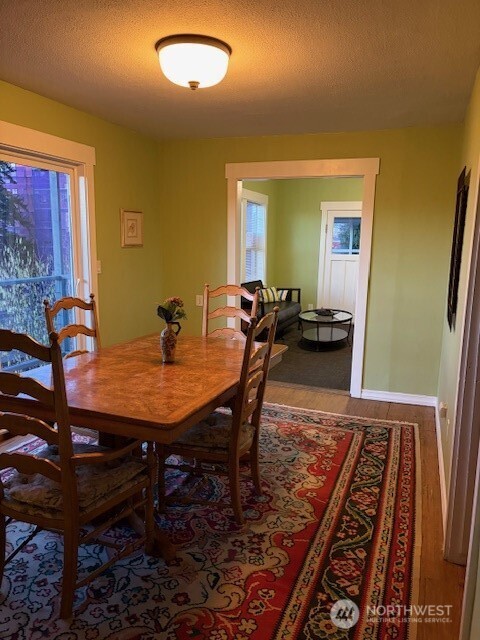 310 East Ivy Street Bellingham, WA 98225 - Photo 13 of 34 a view of a dining room with furniture and wooden floor