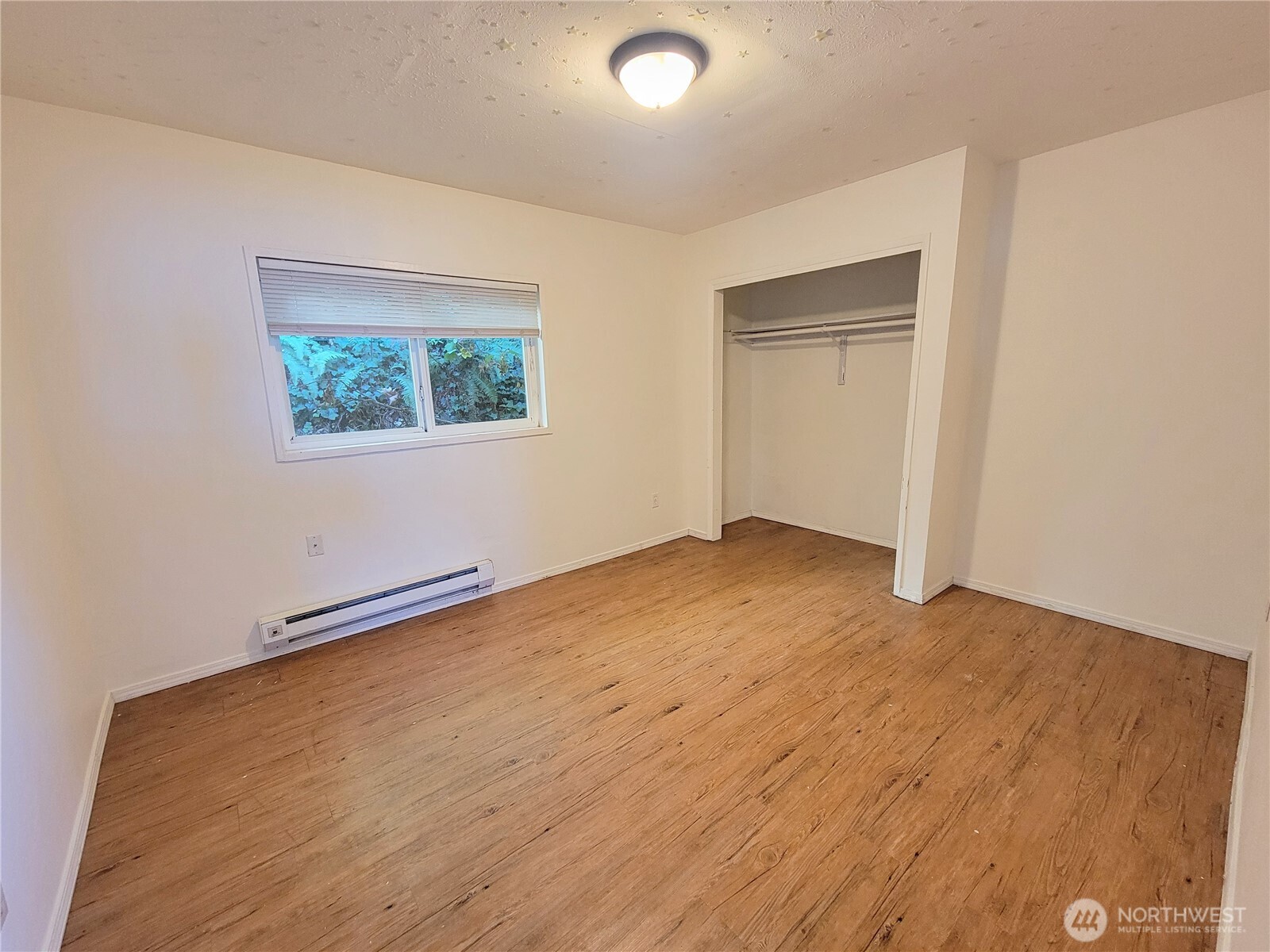 310 East Ivy Street Bellingham, WA 98225 - Photo 27 of 34 a view of an empty room with wooden floor and a window