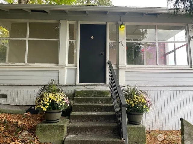 a front view of a house with outdoor seating