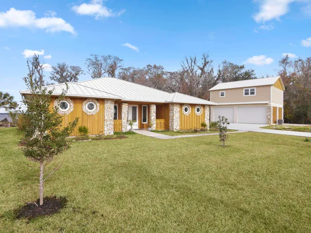 a view of a house with a yard