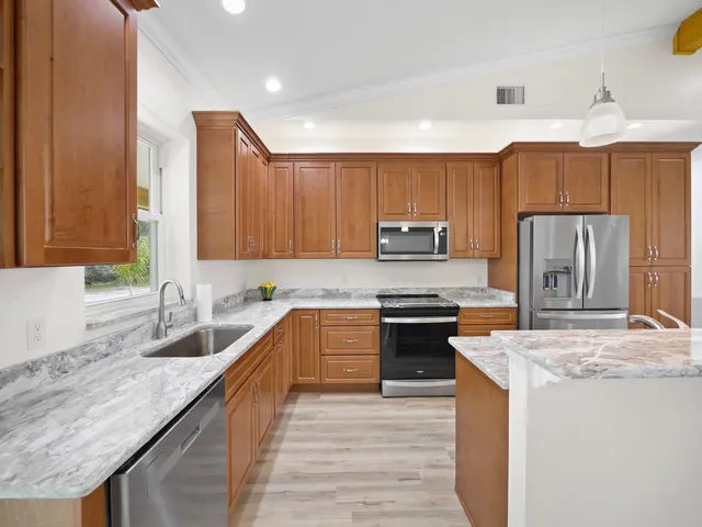 a kitchen with a sink stove and microwave