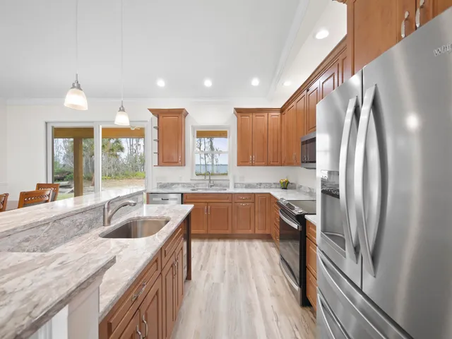 a large kitchen with a large counter top appliances and cabinets