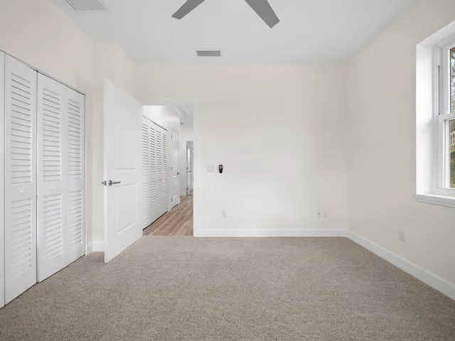 a kitchen with stainless steel appliances granite countertop a stove a sink dishwasher and a refrigerator with wooden floor