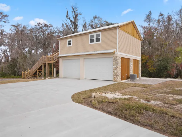 a kitchen with a sink wooden floor and stainless steel appliances