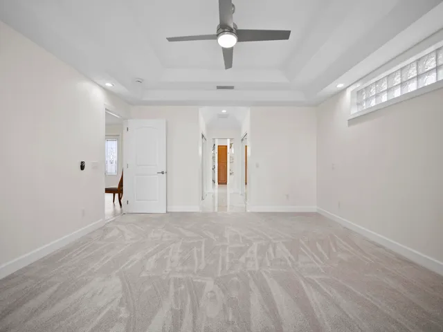 a bathroom with a glass shower door and a glass door