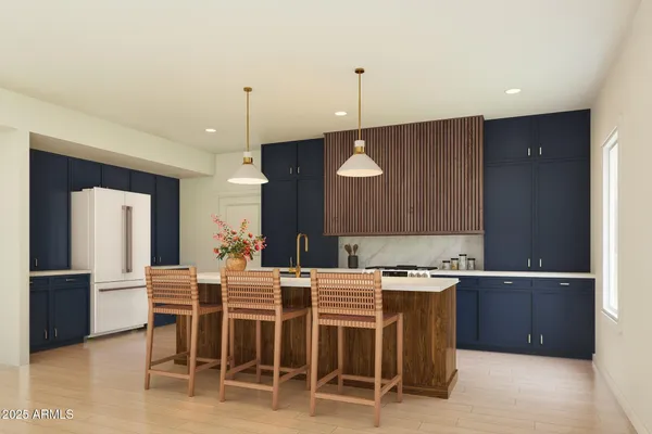 a kitchen with a dining table chairs and cabinets