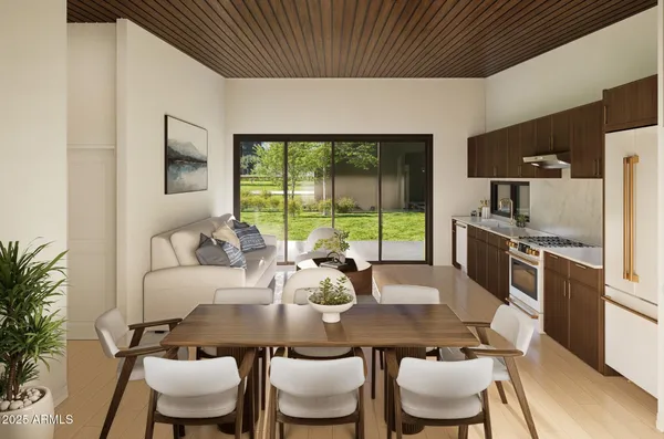 a dining room with furniture and large windows