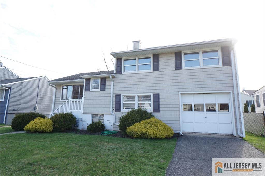 32 Predmore Avenue Colonia, NJ 07067 - Photo 1 of 28 a front view of a house with a garden