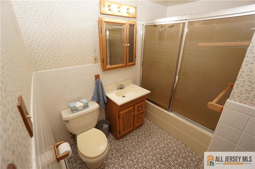32 Predmore Avenue Colonia, NJ 07067 - Photo 18 of 28 a bathroom with a toilet a sink and a shower