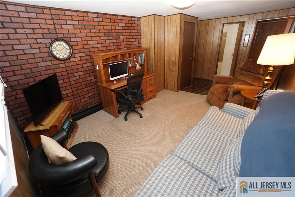 32 Predmore Avenue Colonia, NJ 07067 - Photo 20 of 28 a bedroom with furniture and a fireplace