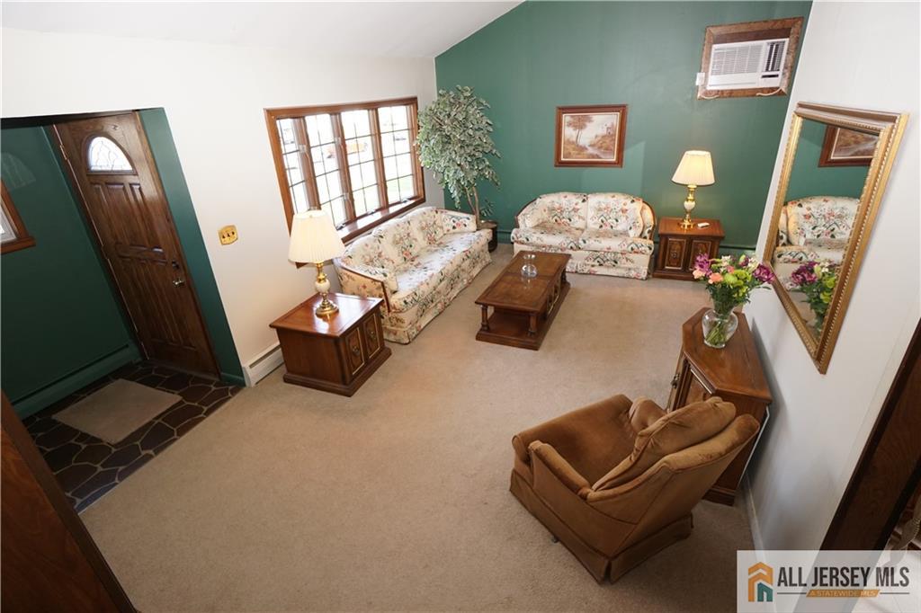 32 Predmore Avenue Colonia, NJ 07067 - Photo 4 of 28 a living room with furniture and a mirror