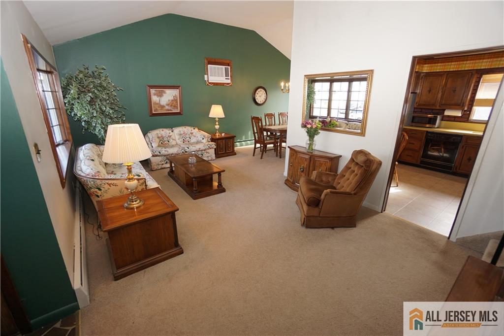32 Predmore Avenue Colonia, NJ 07067 - Photo 5 of 28 a living room with furniture and a fireplace