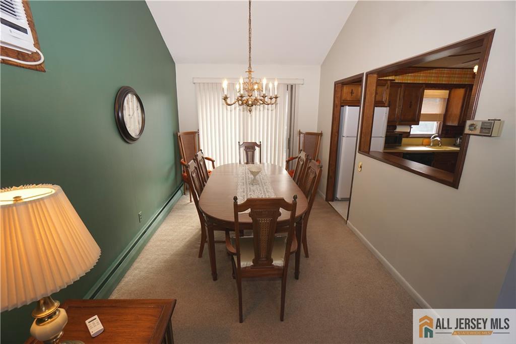32 Predmore Avenue Colonia, NJ 07067 - Photo 7 of 28 a view of a dining room with furniture and a chandelier