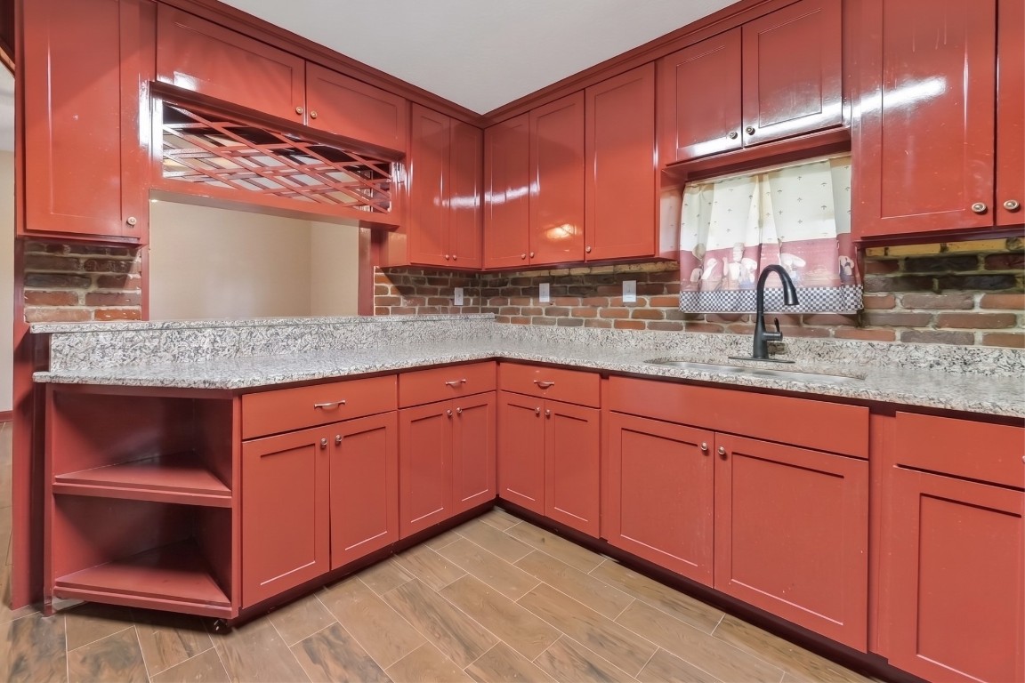 6014 Linda Drive Rosharon, TX 77583 - Photo 13 of 23 A unique built-in wine rack and open shelving at the end of the counter run add character and utility to the kitchen’s spacious layout.