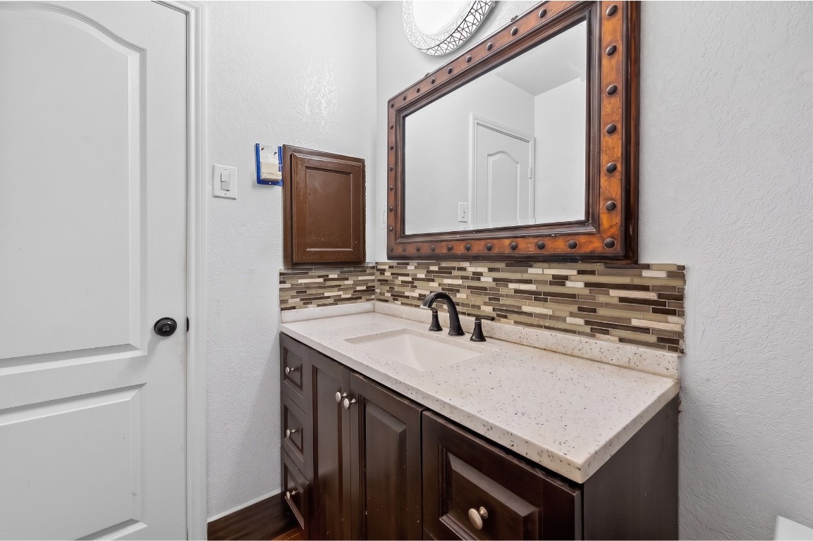 6014 Linda Drive Rosharon, TX 77583 - Photo 15 of 23 A spacious dark-wood vanity provides functional storage with a mix of cabinets and drawers, complemented by a built-in recessed medicine chest.