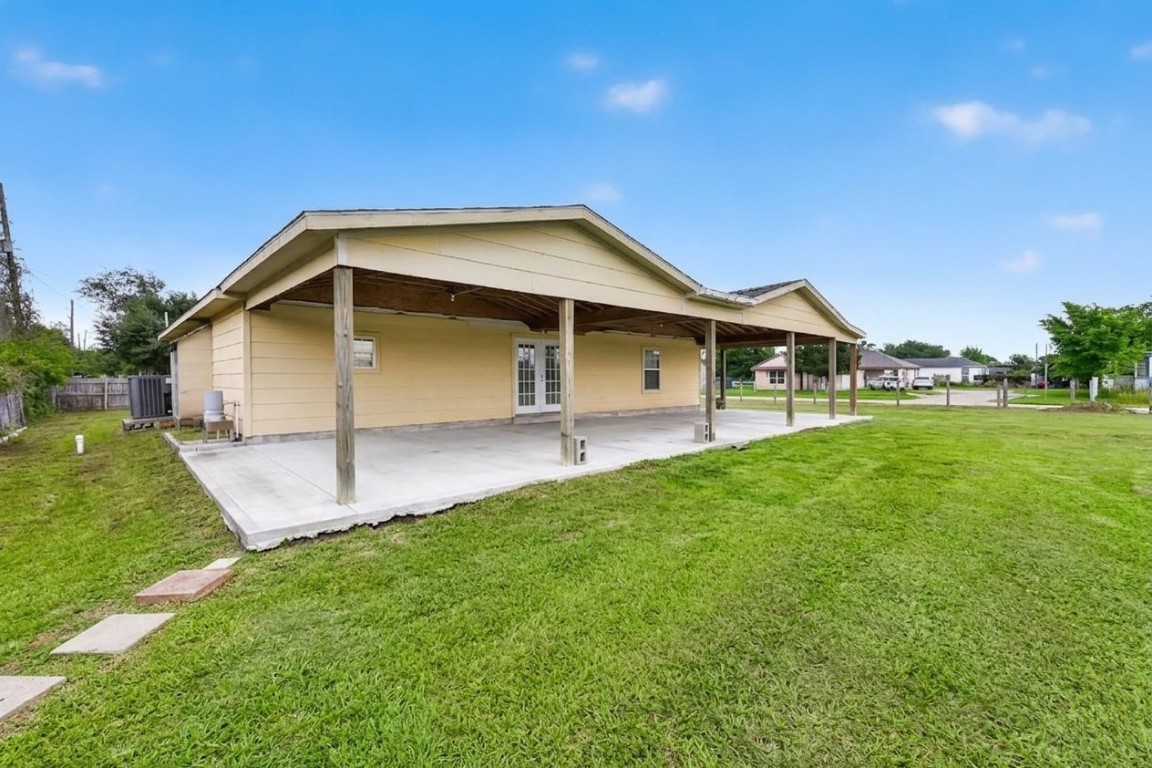 6014 Linda Drive Rosharon, TX 77583 - Photo 22 of 23 The expansive concrete patio provides a vast, sheltered area for outdoor gatherings overlooking the greenery.